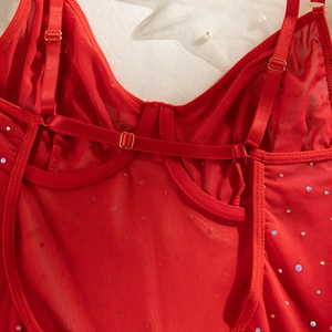 Detailed macro view of red mesh fabric with colorful sequins and adjustable gold straps