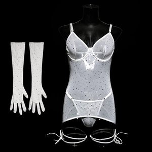 Close-up of white mesh lingerie set with sparkling sequins and matching gloves