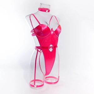 Detailed view of hot pink bodysuit with heart rings and garter straps on mannequin