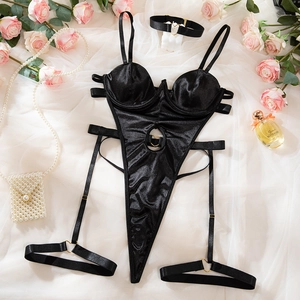 Detail of black satin bodysuit featuring heart-shaped cutout and gold metal buckle detail