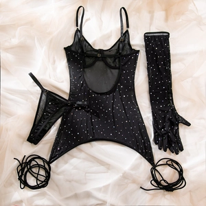 Close-up of black mesh lingerie set with shiny sequins, including gloves and stockings