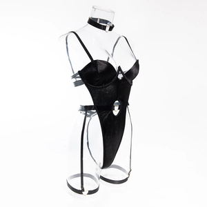 Detail view of black satin bodysuit set with heart-shaped metal buckles and leg straps