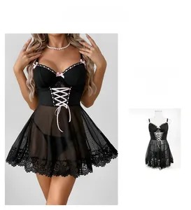 Detail of black lace lingerie set featuring pink bows and corset-style lace-up ribbons