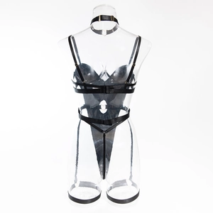 Detail of black strappy lingerie set with metallic buckles and adjustable elastic bands
