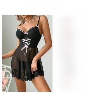 Detailed view of black mesh babydoll with pink ribbon accents and eyelash lace trim