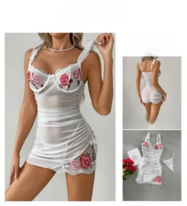 Detailed view of white mesh lingerie with rose embroidery and ruched lace cups