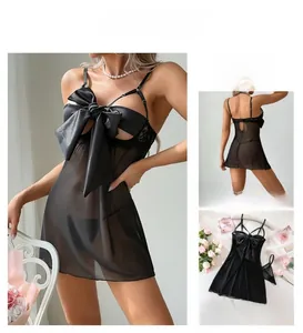 Detailed view of sheer black mesh lingerie set featuring a large satin bow and lace trim