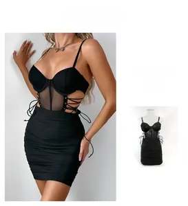 Detail of black bodycon dress featuring mesh panels, side lace-up cutouts, and corset style