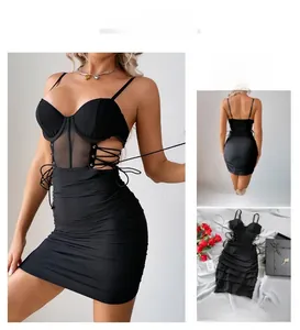 Detail of black corset mini dress featuring sheer mesh panels and side lace-up drawstring