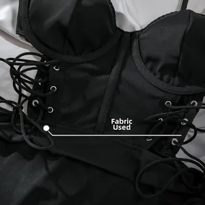 Detail of corset dress with metal eyelets, lace-up strings, and structured fabric texture