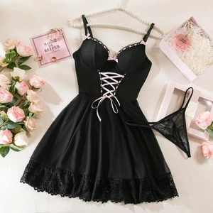 Detailed flat lay of black sheer lace lingerie set with pink ribbons and lace hem