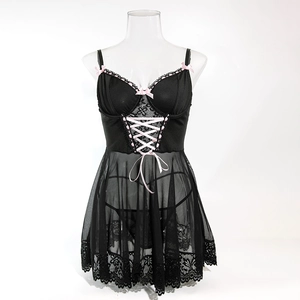Detail of black sheer lace sleepwear set featuring pink ribbon lacing and bow accents