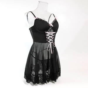 Close-up of black sheer mesh nightdress with lace trim and pink ribbon bow detail