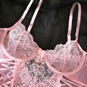 Detail of pink lace bodysuit with underwire cups, floral patterns and satin ribbon accents