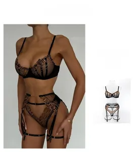 Detail of black mesh lingerie set with intricate bronze chain embroidery and underwire