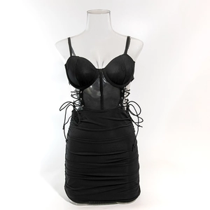 Detail of corset-style bodice with underwire cups and sheer mesh waist on black mini dress