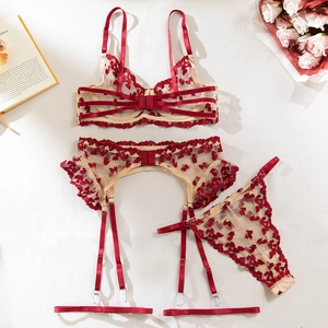 Detail of red leaf embroidery on three-piece lingerie set with bra and garter