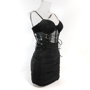 Detail view of black bodycon dress featuring side mesh panels and lace-up corset design