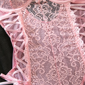 Macro detail of pink floral lace, ribbon lacing and mesh texture on women's bodysuit
