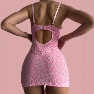Detail of pink leopard print nightgown featuring an open back design and slim fit straps
