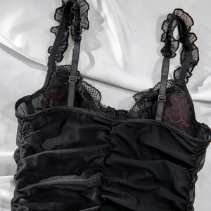 Detail of black mesh teddy with red rose embroidery and delicate lace trim accents