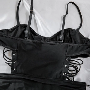 Detail of sexy black mesh bodysuit with adjustable straps and side lace-up cutout design