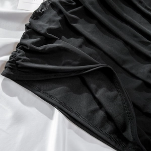 Detail of black mesh fabric with ruching texture and clean bottom hem stitching
