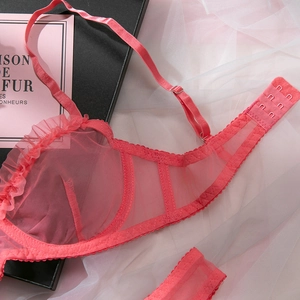 Detail of pink sheer mesh bra with ruffled edges and adjustable straps in a gift box