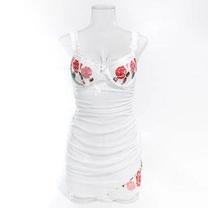 Close-up of white lace bodysuit with red rose embroidery and underwire cups
