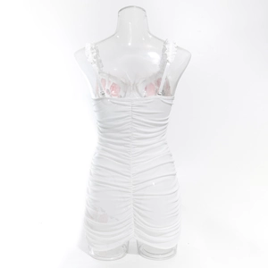Detailed back view of white ruched mini dress with thin straps and bodycon fit
