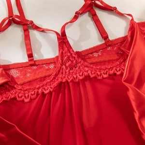 Detail of red satin lingerie with delicate lace trim and adjustable multi-shoulder straps