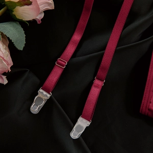 Detail of burgundy adjustable garter straps with silver buckles and secure clips