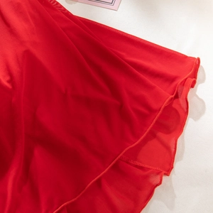 Detailed close-up of red mesh fabric with delicate wavy lettuce edges and fine texture