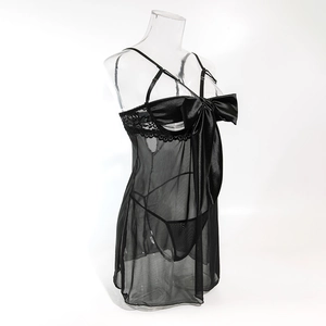 Detail of sheer black mesh lingerie set featuring a large satin bow and lace trim