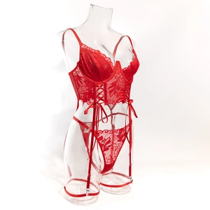 Detailed close-up of red floral lace corset with underwire and matching garter belt straps
