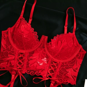 Detail of red lace bodysuit with underwire support and adjustable drawstring waist