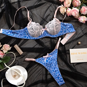 Detail of blue leopard print lace lingerie set with pink bow accents and underwire bra