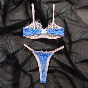 Detailed macro shot of blue leopard print lace lingerie set with pink shoulder straps