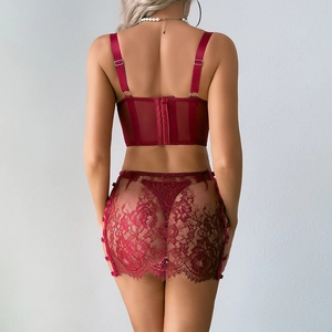Detailed back view of red mesh bodysuit with intricate lace embroidery and clasp closure