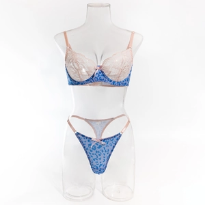 Detailed view of blue leopard print lingerie set with delicate pink lace and bow accents