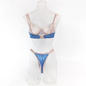 Close-up of blue leopard print lingerie set with delicate lace and pink straps