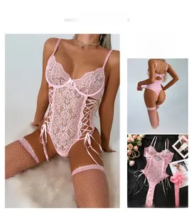 Pink lace bodysuit set with criss-cross ribbon details and matching fishnet stockings