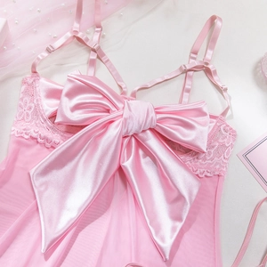 Detailed close-up of pink mesh lingerie featuring a large satin bow and lace trim