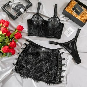 Detailed view of black lace lingerie set with eyelash texture on grey satin background