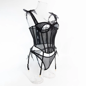 Detail of black mesh corset with boning, silk bows, and matching garter belt set