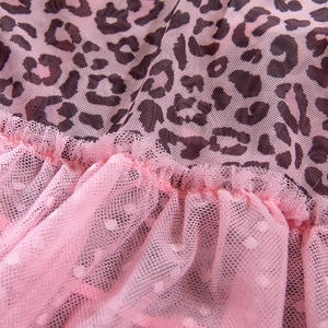 Détail de maille rose imprimé léopard et couches de tulle à volants sur la robe