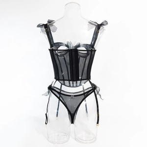 Detail view of black mesh corset lingerie set with ribbon bows and garter straps
