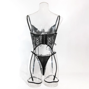 Detailed view of black lace corset lingerie with underwire, boning, and garter straps