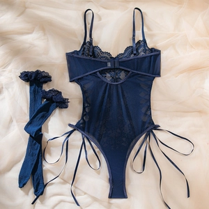 Detailed flat lay of blue lace bodysuit with cross tie design and matching stockings
