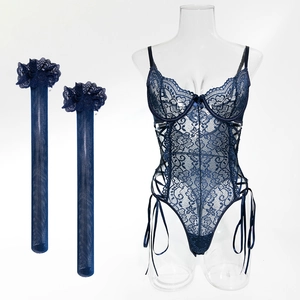 Detail view of dark blue lace bodysuit with side lace-up design and matching stockings